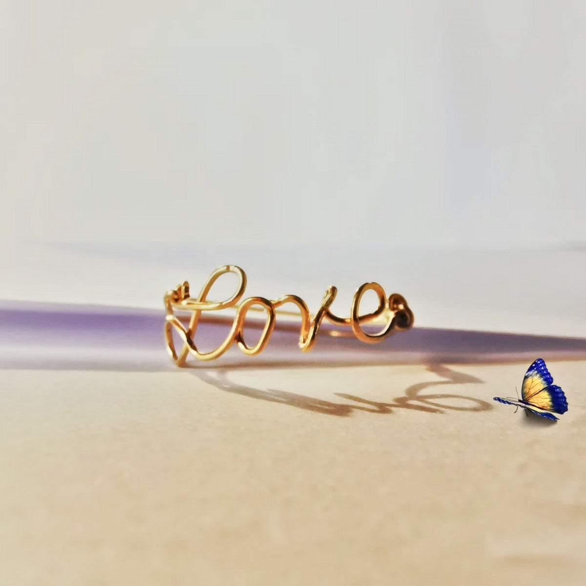 Bague prénom en or présentée sur une surface, bijou personnalisé à l’allure délicate